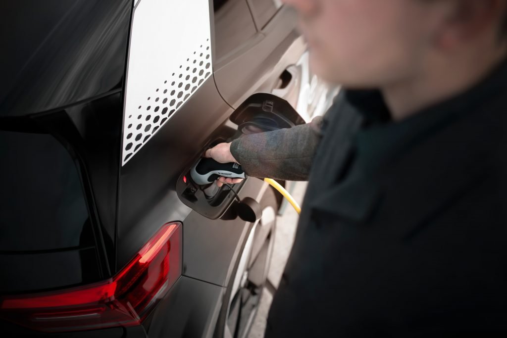 Person plugging charger in a car