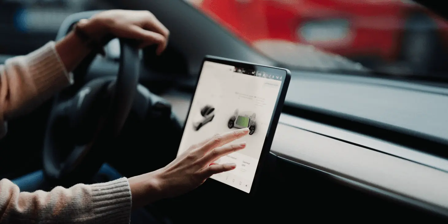 woman checking her in-car navigation screen